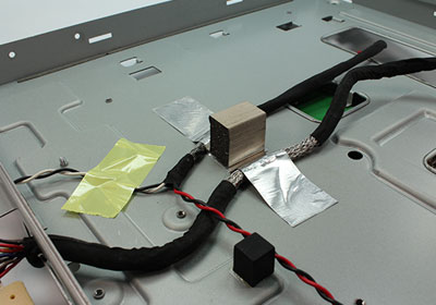 A foam gasket is attached to a metal case and used for grounding purposes