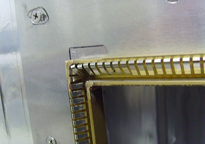 Metal finger gaskets surrounding the metal frame